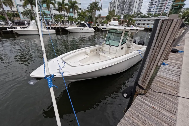 32 Boston Whaler Outrage 2013 Yacht Photos Pics 2013 Boston Whaler 320 Outrage docked at marina with palm trees and buildings.