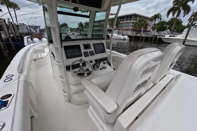 32 Boston Whaler Outrage 2013 Yacht Photos Pics 2013 Boston Whaler 320 Outrage boat interior with helm, steering wheel, and seating.