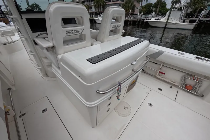 32 Boston Whaler Outrage 2013 Yacht Photos Pics 2013 Boston Whaler 320 Outrage boat interior with seating and storage, docked by the water.