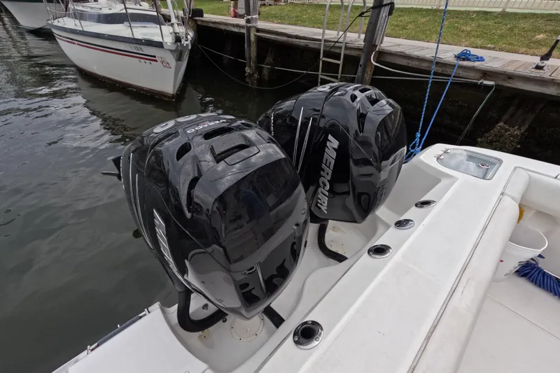 32 Boston Whaler Outrage 2013 Yacht Photos Pics 2013 Boston Whaler 320 Outrage with twin Mercury outboard engines docked by the water.