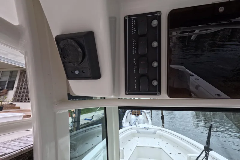 32 Boston Whaler Outrage 2013 Yacht Photos Pics 2013 Boston Whaler 320 Outrage control panel and speaker, docked by the water.