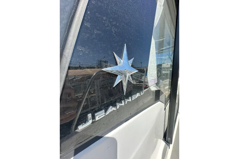 Destination Unknown II Yacht Photos Pics 2021 Jeanneau NC895 boat logo on window with star emblem.