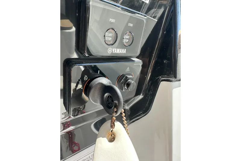 Destination Unknown II Yacht Photos Pics Control panel of 2021 Jeanneau NC895 boat with Yamaha start/stop buttons and key ignition.