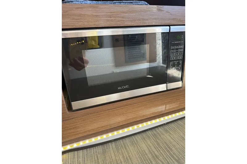 Destination Unknown II Yacht Photos Pics Microwave oven in 2021 Jeanneau NC895 boat interior, wood paneling.