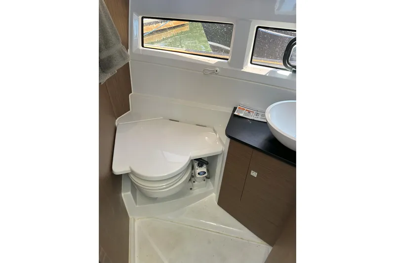 Destination Unknown II Yacht Photos Pics 2021 Jeanneau NC895 boat bathroom with compact toilet and sink.