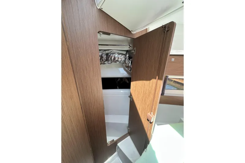 Destination Unknown II Yacht Photos Pics Interior view of 2021 Jeanneau NC895 boat, featuring a wooden door and modern design.