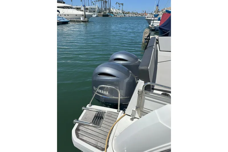 Destination Unknown II Yacht Photos Pics 2021 Jeanneau NC895 with Yamaha outboard engines docked in a marina.