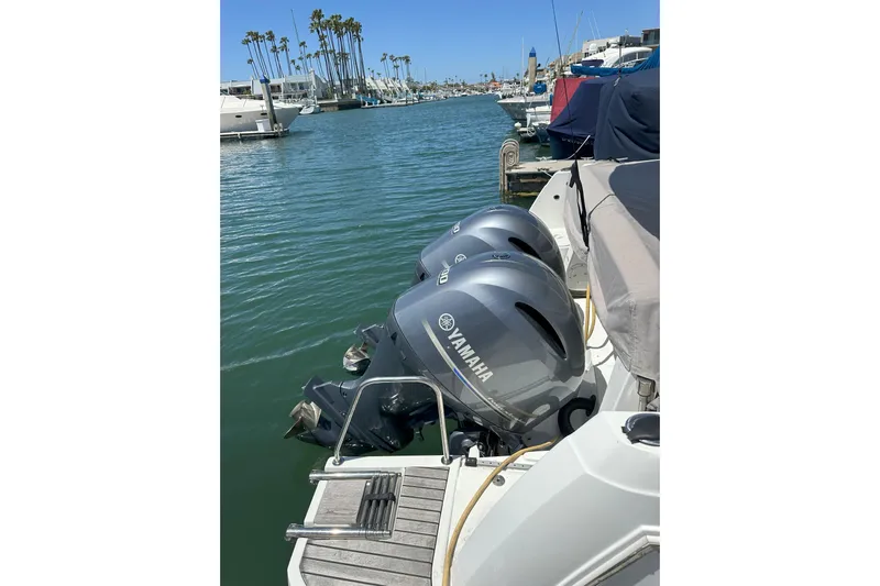 Destination Unknown II Yacht Photos Pics 2021 Jeanneau NC895 with twin Yamaha outboard engines docked in a marina.