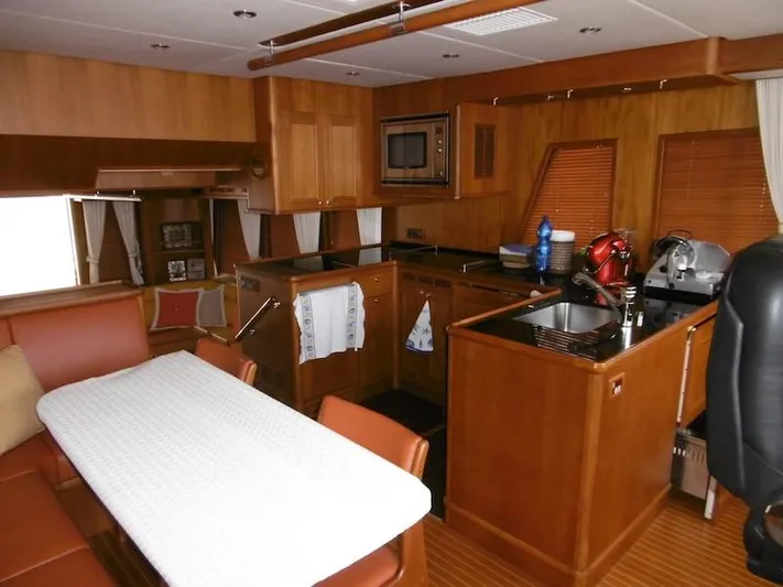 Saturnia Yacht Photos Pics Luxurious 2009 Grand Banks 59 Aleutian RP yacht interior with modern kitchen and dining area.