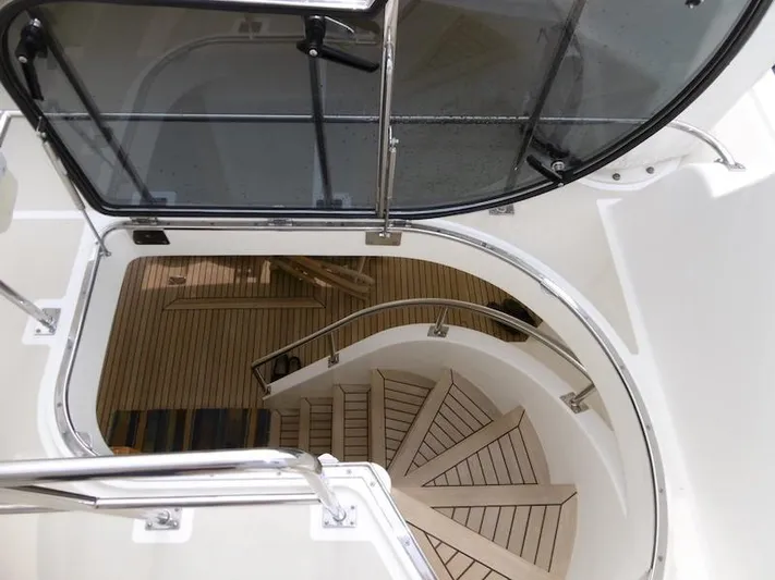 Saturnia Yacht Photos Pics Staircase view on 2009 Grand Banks 59 Aleutian RP yacht, featuring sleek design and wood finish.