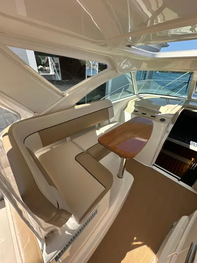  Yacht Photos Pics 2014 Tiara Yachts 3100 Coronet interior with seating and table, showcasing luxury design.
