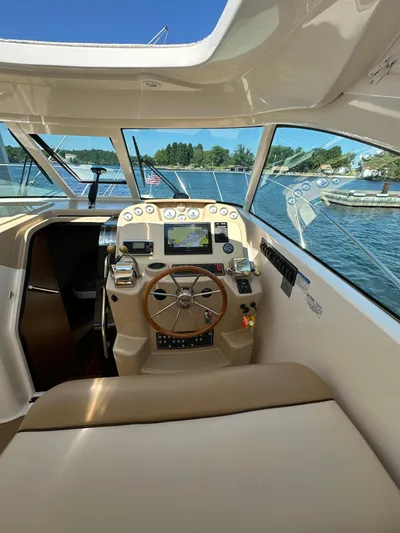 Yacht Photos Pics 2014 Tiara Yachts 3100 Coronet helm with navigation controls, docked on a sunny day.