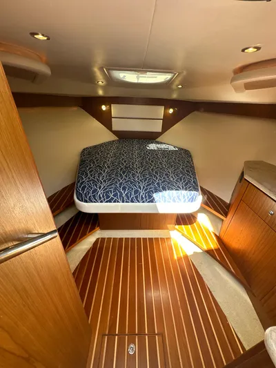  Yacht Photos Pics 2014 Tiara Yachts 3100 Coronet cabin with bed, wood flooring, and modern lighting.