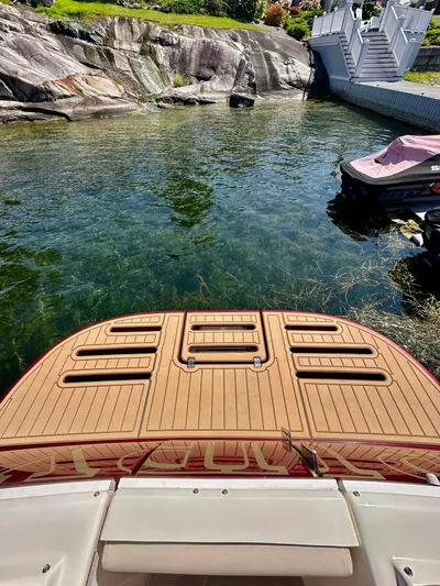  Yacht Photos Pics 2014 Tiara Yachts 3100 Coronet with teak deck near rocky shoreline.