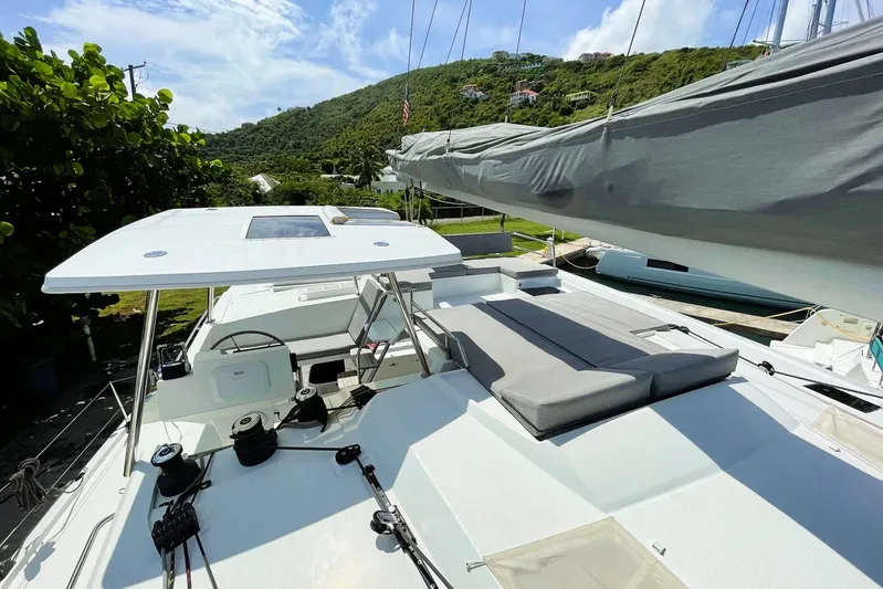 Idalia Yacht Photos Pics 2020 Fountaine Pajot Saona 47 Maestro catamaran with spacious deck and scenic backdrop.
