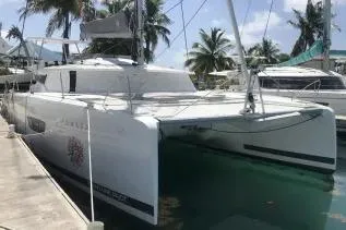 Idalia Yacht Photos Pics 2020 Fountaine Pajot Saona 47 Maestro catamaran docked in a tropical marina.