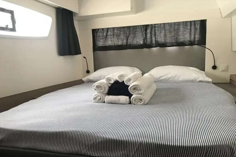 Idalia Yacht Photos Pics Interior cabin of 2020 Fountaine Pajot Saona 47 Maestro with neatly arranged bed and towels.