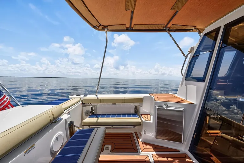  Yacht Photos Pics 2024 Ranger Tugs R-27 boat deck with seating, canopy, and ocean view.