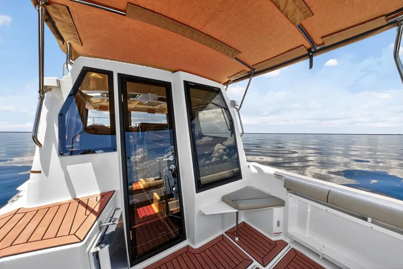  Yacht Photos Pics 2024 Ranger Tugs R-27 boat interior with glass doors and ocean view.