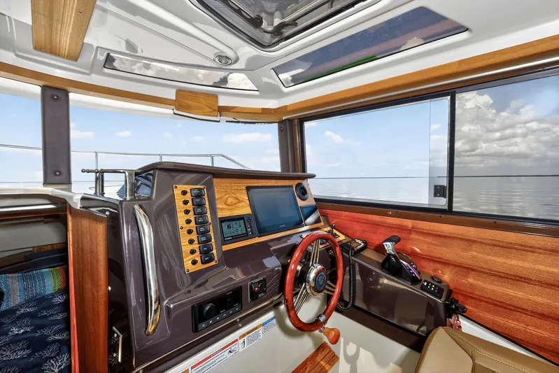  Yacht Photos Pics 2024 Ranger Tugs R-27 helm with modern controls and panoramic water view.