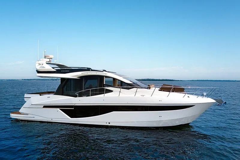 American Pride Yacht Photos Pics 2023 Galeon 470 Sky yacht on calm blue water under clear sky.