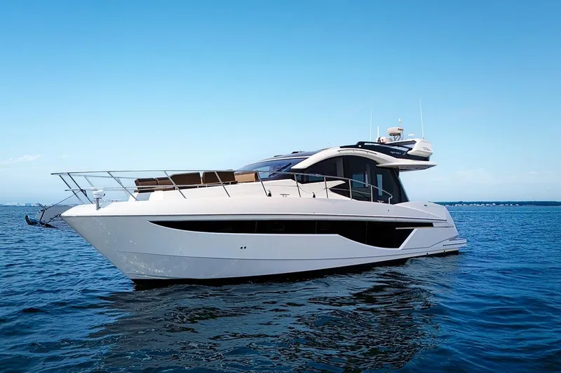 American Pride Yacht Photos Pics 2023 Galeon 470 Sky yacht cruising on open water under clear blue sky.