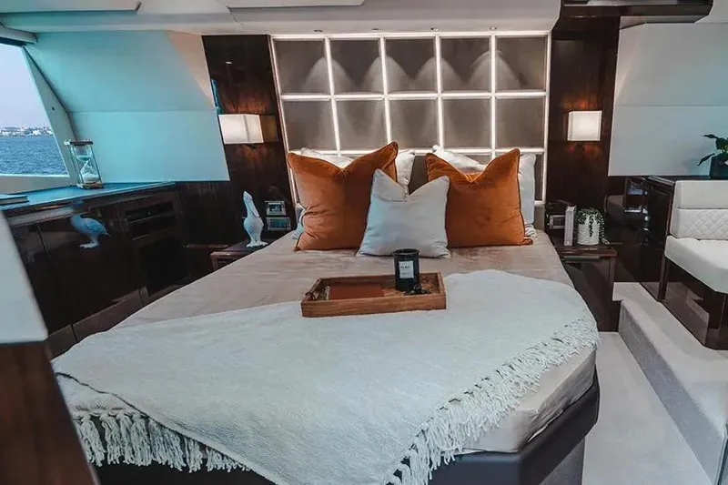 American Pride Yacht Photos Pics Luxurious bedroom interior of 2023 Galeon 470 Sky yacht with elegant decor and cozy bedding.
