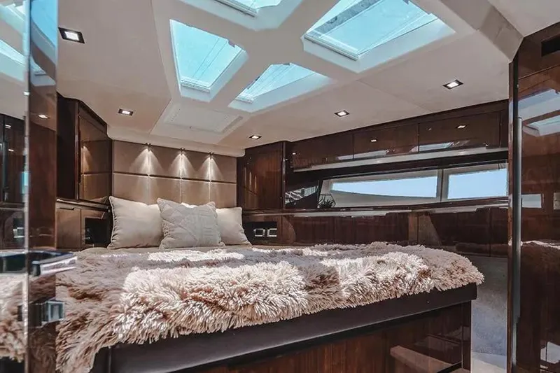 American Pride Yacht Photos Pics Luxurious interior of 2023 Galeon 470 Sky yacht with plush bedding and skylights.