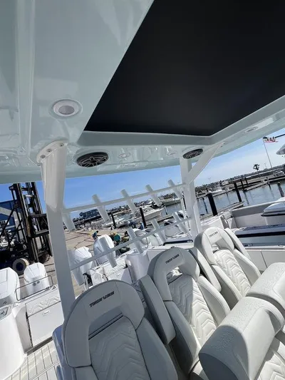 Under Dealer Cost Yacht Photos Pics 2024 Twin Vee 400 Center Console GFX boat interior with luxurious seating at a marina.