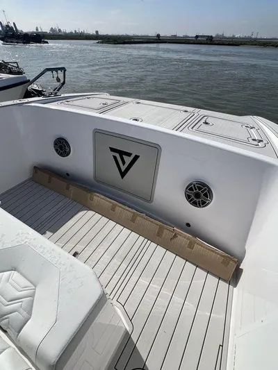 Under Dealer Cost Yacht Photos Pics 2024 Twin Vee 400 Center Console GFX boat deck with logo, speakers, and seating.