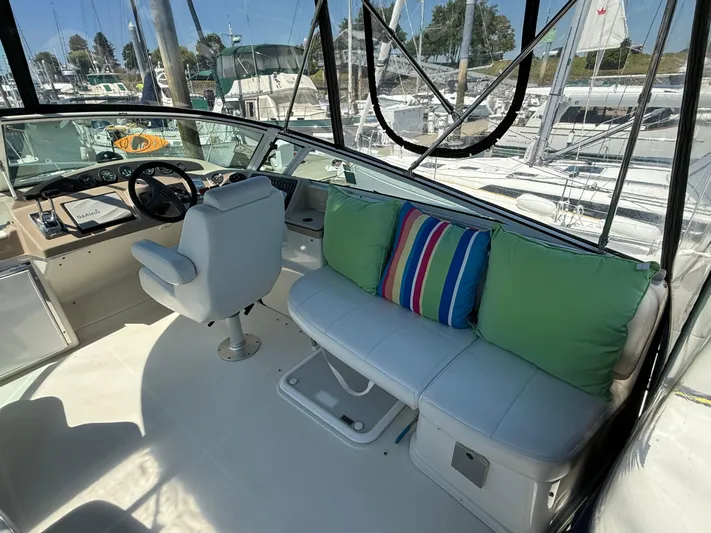  Yacht Photos Pics 2006 Carver 36 Mariner cockpit with white seating, colorful cushions, and steering console.