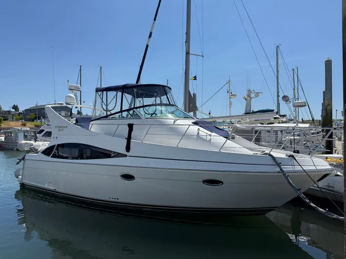  Yacht Photos Pics 2006 Carver 36 Mariner yacht docked at marina under clear blue sky.