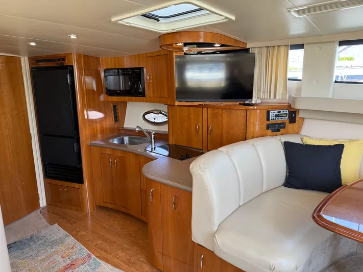  Yacht Photos Pics 2006 Carver 36 Mariner interior with kitchenette, TV, and seating area.