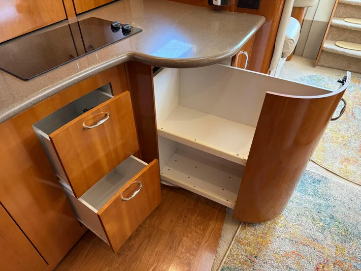 Yacht Photos Pics 2006 Carver 36 Mariner kitchen with open cabinets and drawers, featuring a sleek countertop.