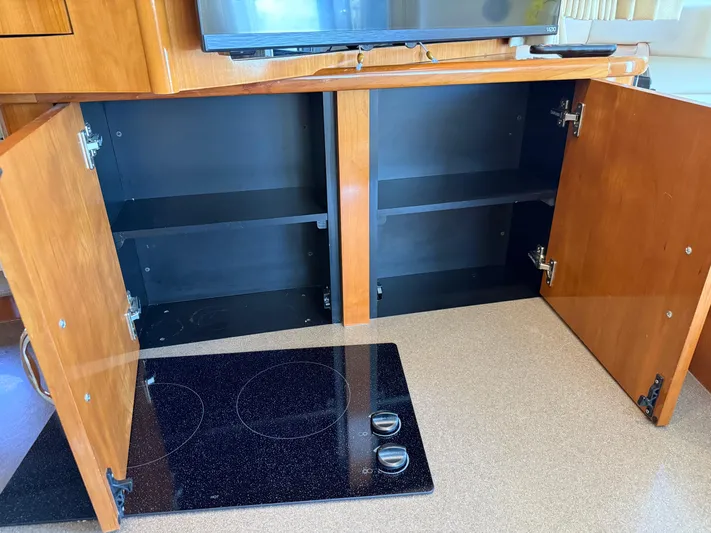  Yacht Photos Pics Open wooden cabinets and stovetop in 2006 Carver 36 Mariner yacht kitchen.