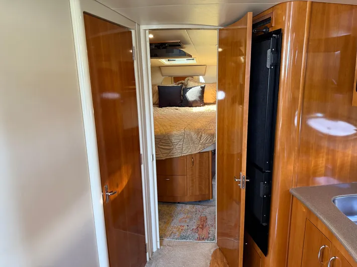  Yacht Photos Pics Interior of 2006 Carver 36 Mariner yacht, featuring cozy bedroom and wooden cabinetry.