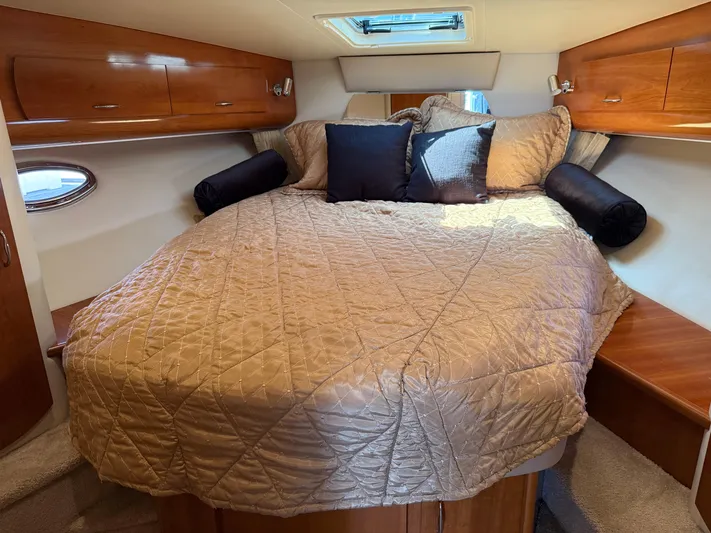  Yacht Photos Pics Luxurious cabin interior of 2006 Carver 36 Mariner with cozy bed and wooden cabinets.