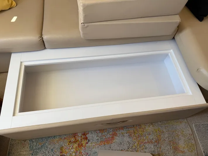  Yacht Photos Pics Open storage compartment on a 2006 Carver 36 Mariner boat, beige seating, colorful rug.