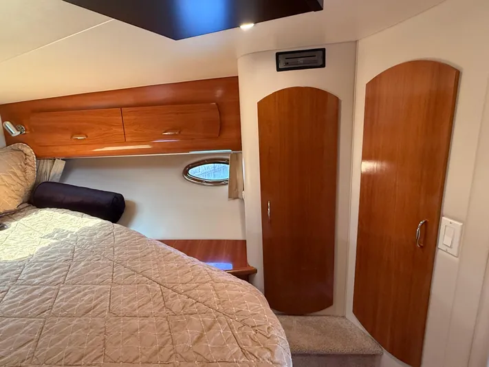  Yacht Photos Pics Interior of 2006 Carver 36 Mariner yacht with wood cabinets and cozy bedding.