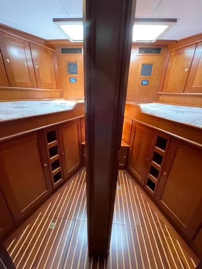 Dame De Coeur Yacht Photos Pics 1982 Cheoy Lee 66 LRC yacht interior with wooden cabinetry and twin beds.