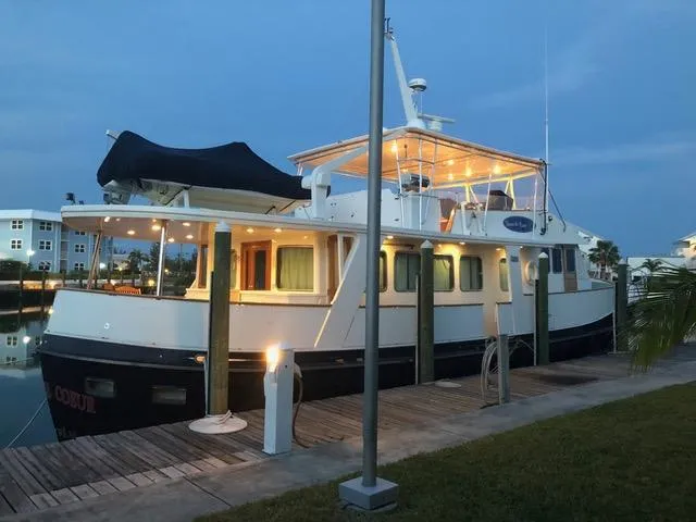 Dame De Coeur Yacht Photos Pics 1982 Cheoy Lee 66 LRC yacht docked at sunset, illuminated and ready for voyage.