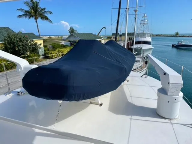 Dame De Coeur Yacht Photos Pics 1982 Cheoy Lee 66 LRC yacht deck with covered equipment, marina view, and palm trees.