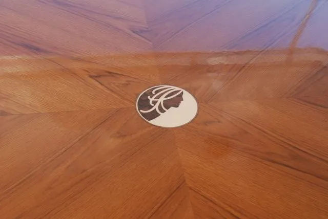 Dame De Coeur Yacht Photos Pics Polished wooden floor with a circular inlay design on a 1982 Cheoy Lee 66 LRC yacht.