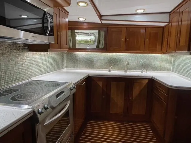 Dame De Coeur Yacht Photos Pics Luxurious kitchen in 1982 Cheoy Lee 66 LRC yacht with modern appliances and wood cabinetry.