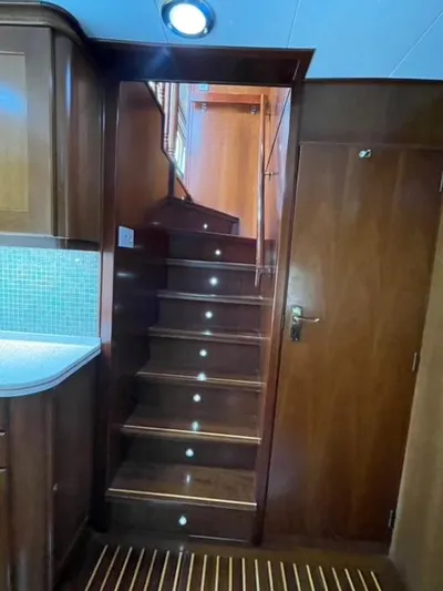Dame De Coeur Yacht Photos Pics Staircase in 1982 Cheoy Lee 66 LRC yacht with wooden finish and LED lighting.