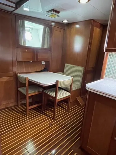 Dame De Coeur Yacht Photos Pics 1982 Cheoy Lee 66 LRC yacht interior with wood paneling and dining area.