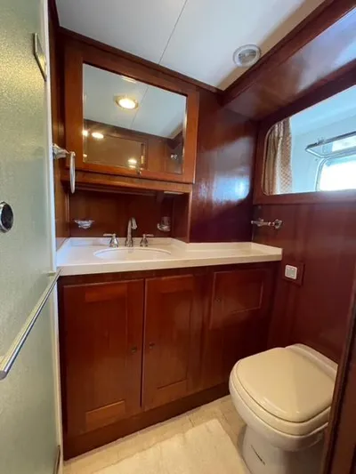 Dame De Coeur Yacht Photos Pics 1982 Cheoy Lee 66 LRC yacht bathroom with wooden cabinetry and modern fixtures.