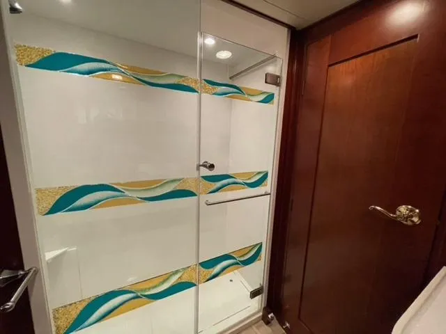 Dame De Coeur Yacht Photos Pics Shower area in 1982 Cheoy Lee 66 LRC yacht with decorative glass design.