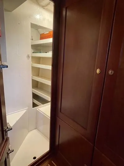 Dame De Coeur Yacht Photos Pics 1982 Cheoy Lee 66 LRC interior with wooden cabinets and built-in shelving.