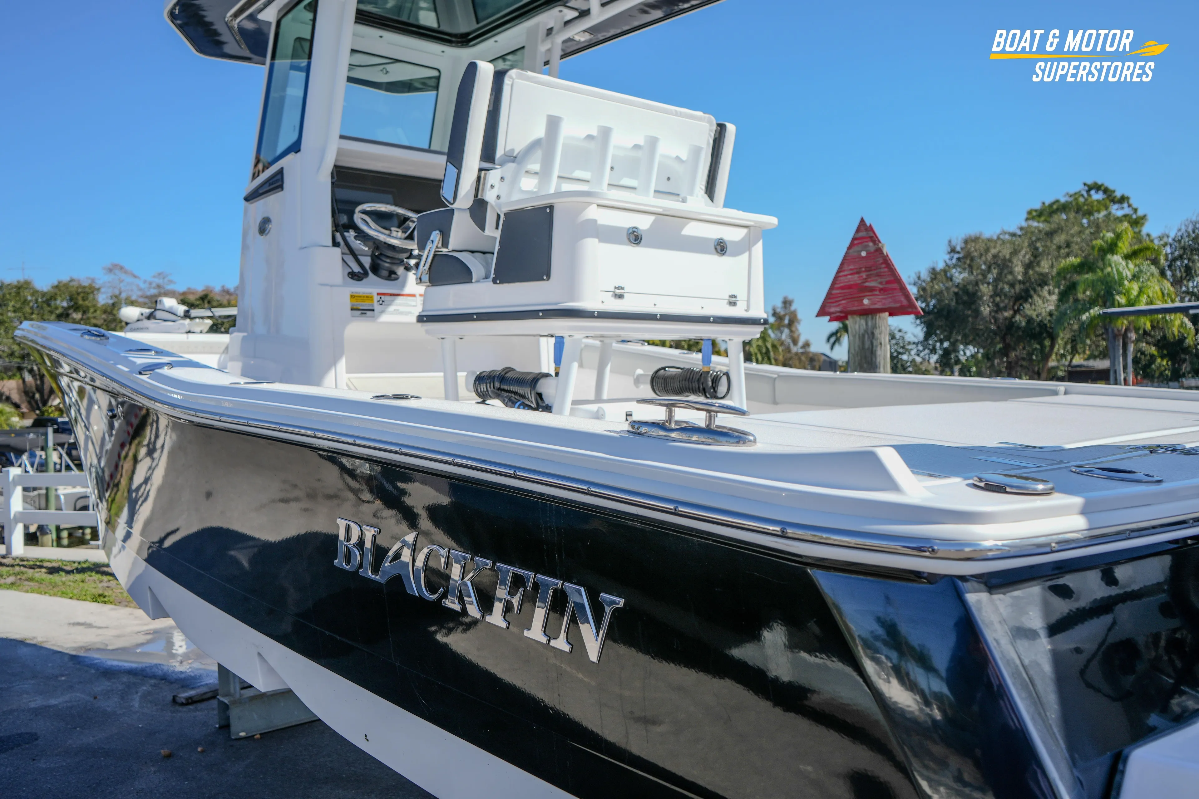 2025 Blackfin 262 HB boat with sleek black hull, showcased outdoors.